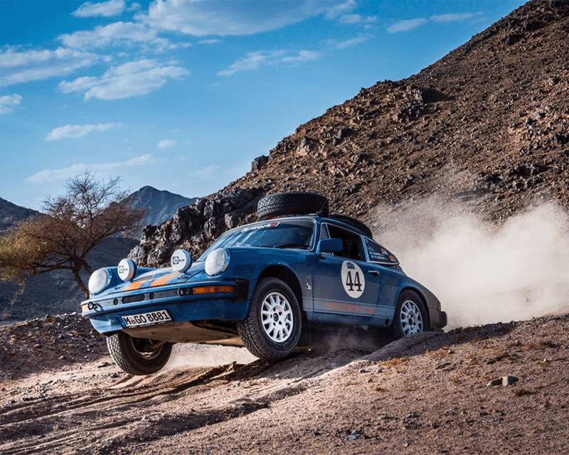 A Porsche 911 rally car in the desert